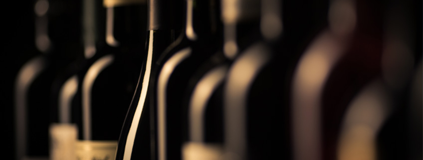 Wine bottles in line after going through a bottle labeling machine.