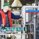 Technician installing a commercial labeling system upgrade.