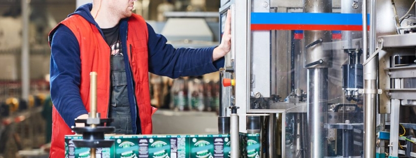 Technician installing a commercial labeling system upgrade.
