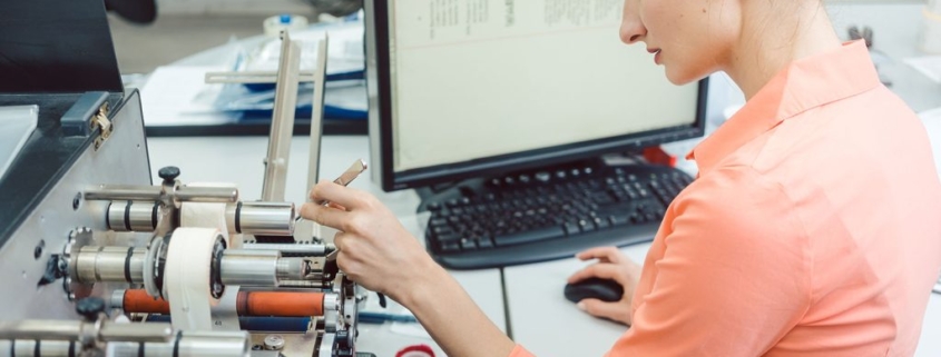 Technician repairing a commercial labeling system.