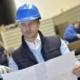 Engineer with mechanical worker checking on production