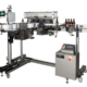 Automatic Bottle Labeling Machine–Vertical Trunnion Roller--loaded with beer bottles.