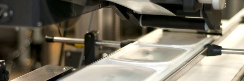 Commercial labeling system applying labels to products.