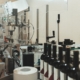 High-speed label applicator on a production line.