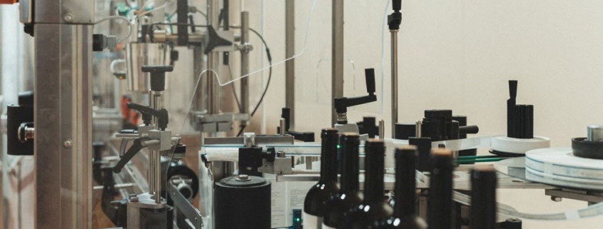 High-speed label applicator on a production line.