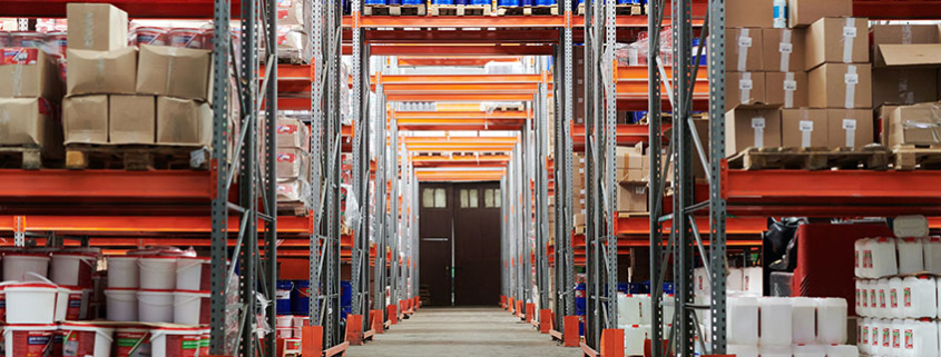Warehouse racks full of various labeled inventory.