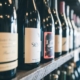 A rack of wine bottles that have high-quality glass bottle labels applied to them.