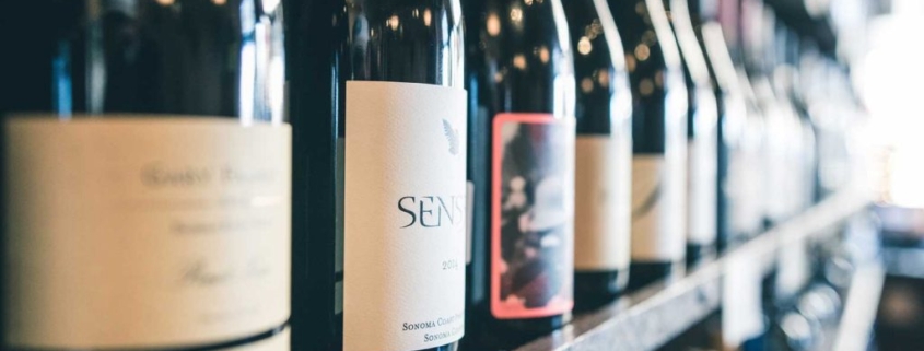 A rack of wine bottles that have high-quality glass bottle labels applied to them.