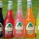 Jarritos labeled craft soda bottles in a straight line.