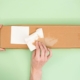 A pressure-sensitive adhesive label peeling off a package.
