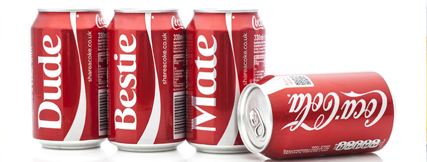 Four Coca Cola Classic cans displaying personalized labels that read “Dude, Bestie, and Mate.”